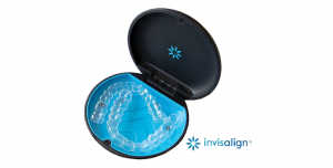 Invisalign clear aligners in a black case with a blue interior, promoting discreet teeth straightening for adults, featured in a dental care holiday gift guide.