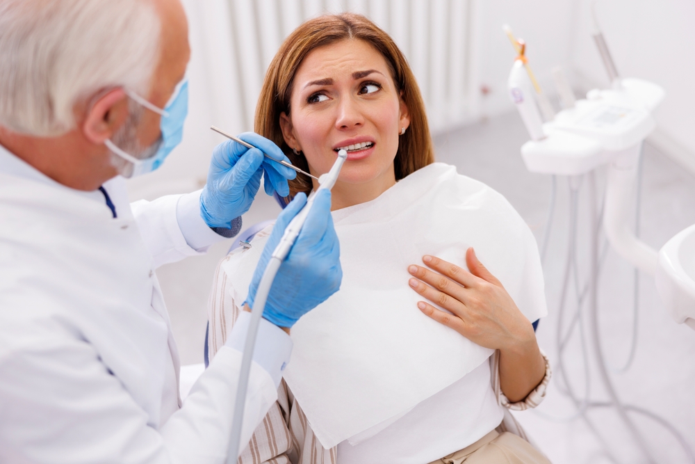 woman sitting in dental chair experiencing dental anxiety